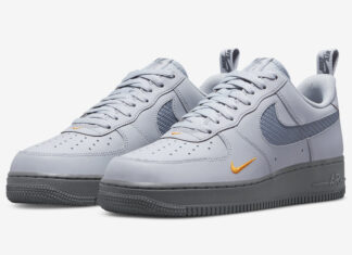 灰色和橙色的Nike Air Force 1，带有镂空的Swooshes。