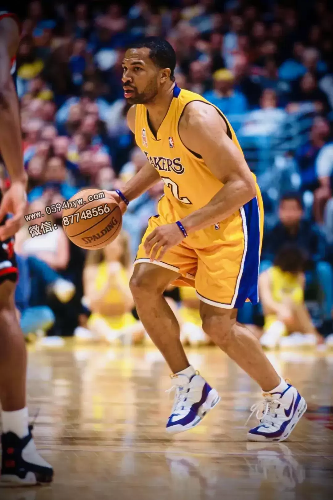 Derek Fisher wearing the Nike Air More Uptempo in a Lakers PE colorway during an NBA game.